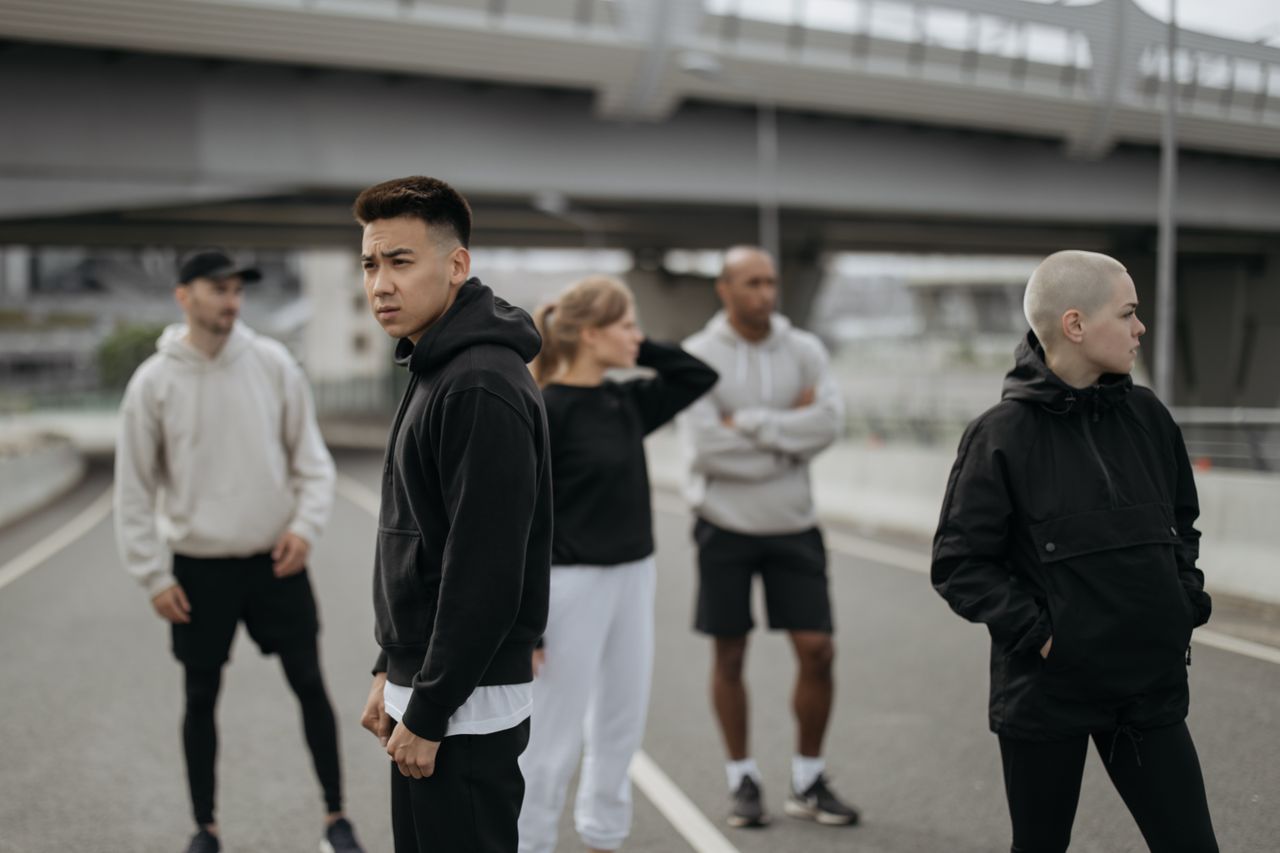 A diverse group of friends wearing activewear in an urban setting. Ideal for lifestyle and sports themes.